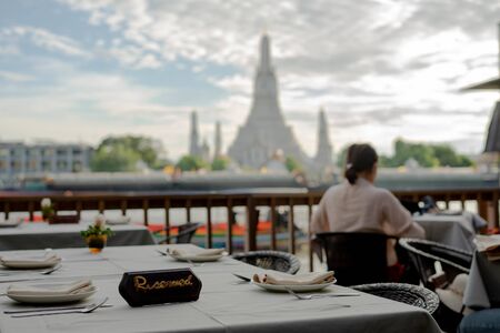 Unidentified Reserve a table eating at the bar restaurant beside Wat Arun Rung or Wat Arun is a beautiful backdrop.の写真素材