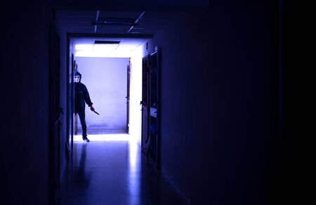 Murder wear the mask holding a knife and Standing in the old apartment, kill and people concept -...