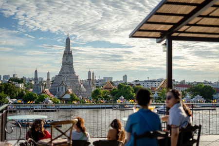 BANGKOK, THAILAND - July 29, 2019: Unidentified Enjoy eating at the bar restaurant beside Wat Arun Rung or Wat Arun is a beautiful backdrop.のeditorial素材