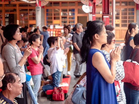 Taipei, Taiwan - May 13, 2019: People Asian with Buddhist incense sticks praying in Longshan Temple....