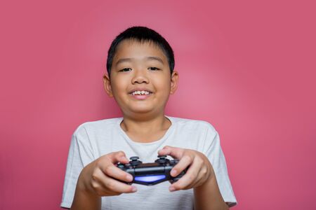 Bangkok, Thailand - September 12, 2019: Hand boy playing Sony Dualshock 4 controller for PlayStation 4 pro, video game-addicted children.のeditorial素材
