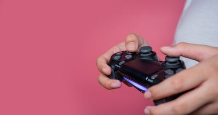 Bangkok, Thailand - September 12, 2019: Hand boy playing Sony Dualshock 4 controller for PlayStation 4 pro, video game-addicted children.のeditorial素材