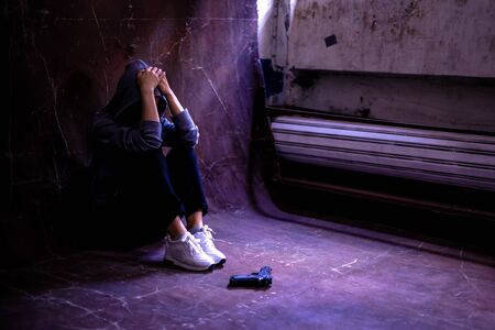 Women with the gun are having stress in life and unable to find a solution and no advisor, from work problems And a failed family life. copy space background for text.の写真素材