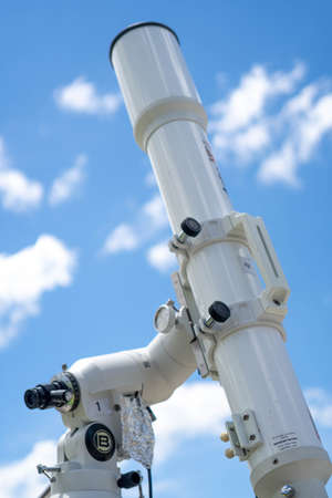 A professional refractor telescope mounted on a tripod.