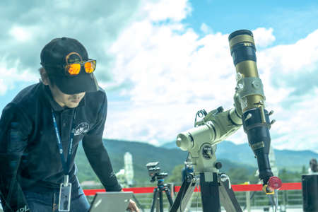 Chiang Mai, Thailand - June 21, 2020 : Partial solar eclipse, Staff setting telescope at Princess...