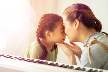 Happy loving family, Mom and daughter playing and kissing, Togetherness concept.の写真素材