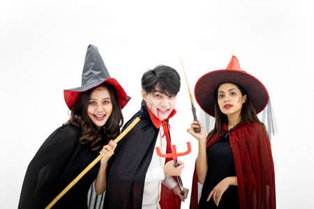 Group of Young Happy Friends Wearing Halloween Costumes having Fun.