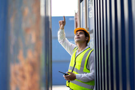 Engineer or supervisor checking and control loading Containers box from Cargo at harbor....