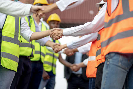 Architects shaking hand at construction site, Finishing successful meeting.