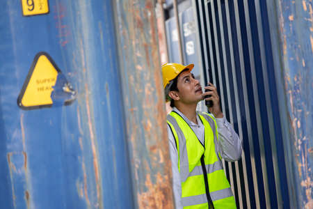 Engineer or supervisor checking and control loading Containers box from Cargo at harbor....