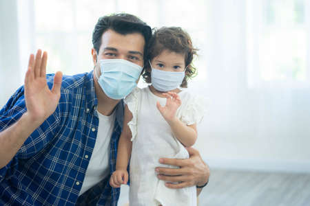 Father and daughter wear face masks, both are wearing face masks for confidence in their health.  protect themselves from dangerous spread of coronavirus covid-19.の写真素材