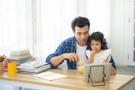 father and daughter, Happy family spending time at home and looking something fanny on tablet.