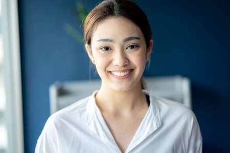 Portrait of young beautiful smiling woman indoors.の写真素材