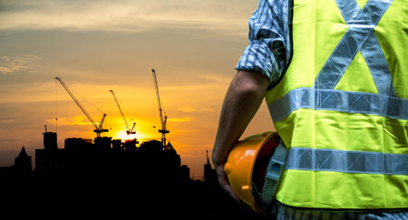 Engineering man standing with yellow safety helmet isolated on white background