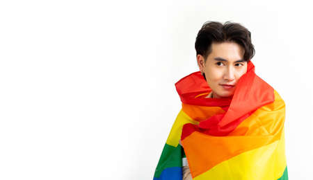 Smiling transgender man with pride flag isolated on white background with copy space. People...
