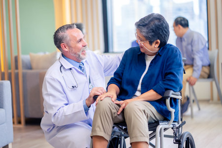 Happy male doctor discussing with senior patientの写真素材