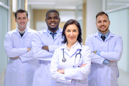 Doctor leading a medical team at the hospital. Professional general practitioners expressing positive emotions.の写真素材