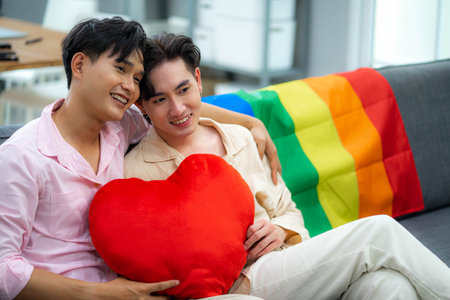 Same sex couple sitting on sofa at home. Concept of LGBT and Love.の写真素材