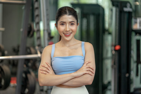 Portrait of young attractive woman smiling to camera at gymの写真素材