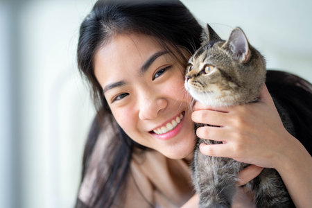 Young woman with cute cat resting at home. Pets and lifestyle concept.の写真素材