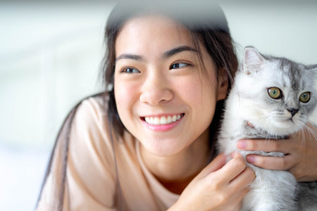Woman at home holding and hug her lovely fluffy cat. lifestyle concept. Friend of human. Pets and lifestyle concept.の写真素材