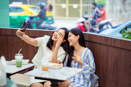 Two women take a selfie at a cafe. communication and friendship concept.