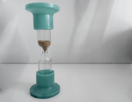 Sand running through the bulbs of an hourglass