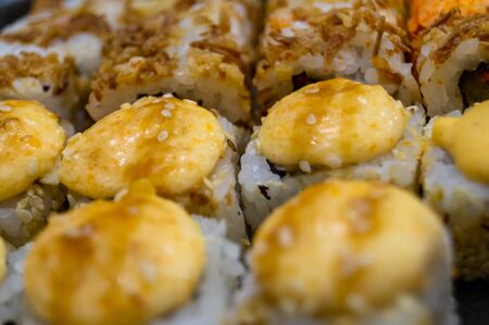 Hot fried Sushi Roll with salmon, avocado and cheese. Sushi menu. Japanese food