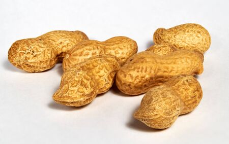 Dried roasted peanuts in closeup. Organic vegan food.