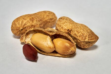 Dried roasted peanuts in closeup. Organic vegan food.