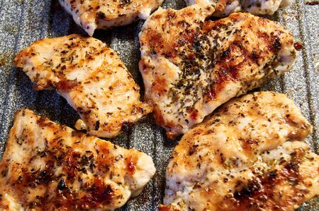 pieces of fried chicken breast. Grilled poultry steak cooked on a grill pan.の写真素材