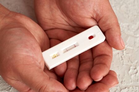 Self-testing of blood for viruses. The girl checks herself for hepatitis, herpes and Epstein-Barr...