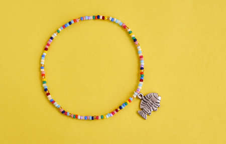 Handmade beadwork, beading as a hobby. Decorations made with your own hands on the background of...