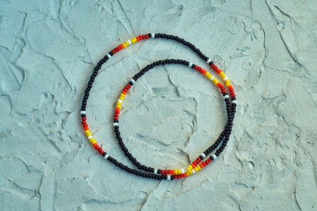 Handmade beadwork, beading as a hobby. Decorations made with your own hands on the background of...