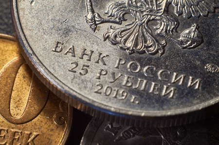Banknotes and coins of the Russian ruble. Details of Russian money in close-up.The inscription Bank of Russia on the coin.The Russian symbol of the double-headed eagleの写真素材