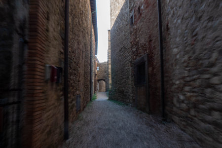 A quiet street of residential buildings in the historic medieval village of Panzano Tuscanyの写真素材