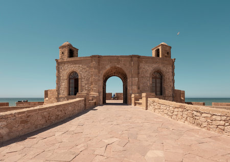 Ancient stone fort entrance at Essaouira coastal UNESCO landmark, with clear blue sky and sunshine in summer, ocean in background Morocco, North Africaのeditorial素材