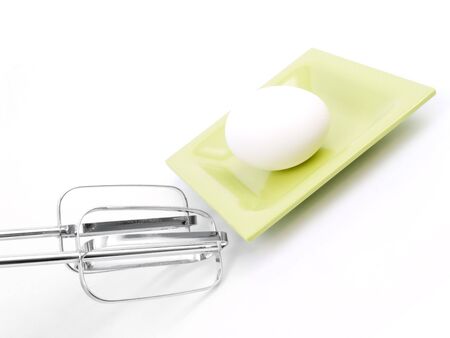 Eggs and Beater on a white backgroundの写真素材