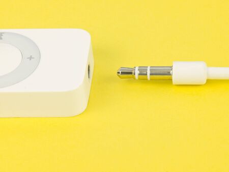Plug with music player on yellow backgroundの写真素材