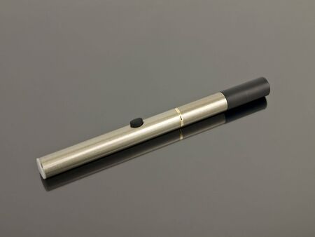Electronic Cigarette with reflection on a silver background