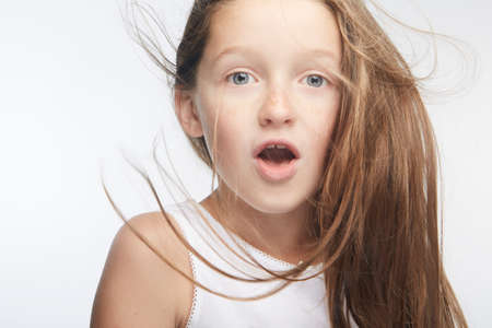 Little girl expressing joy and emotion through her body, her face while keeping the cute effect she wears with her fashion that is well on trend.の写真素材