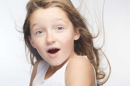 Little girl expressing joy and emotion through her body, her face while keeping the cute effect she wears with her fashion that is well on trend.の写真素材