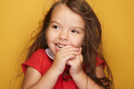 Cute little girl who puts a radiant smile on her face accompanied by her beauty that lights up the world like a ray of sunshine.の写真素材