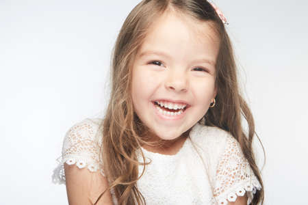 Cute little girl who puts a radiant smile on her face accompanied by her beauty that lights up the world like a ray of sunshine.の写真素材