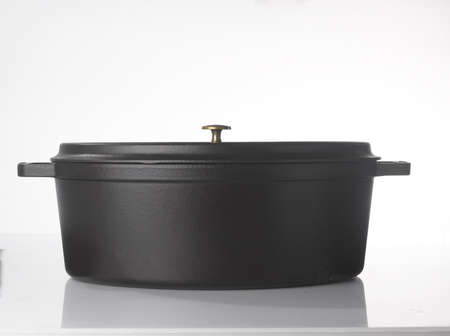 A large black casserole dish that is environmentally friendly and easy to use in the kitchen, safe for children who get a little too close to the kitchen.の写真素材