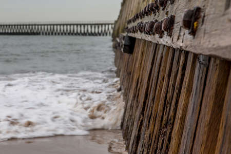 Morning at Blyth beach, with the old wooden Pier stretching out to the North Seaの写真素材