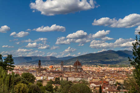 The cityscape of beautiful Florence, Italy, with fluffy clouds in the blue skyの写真素材