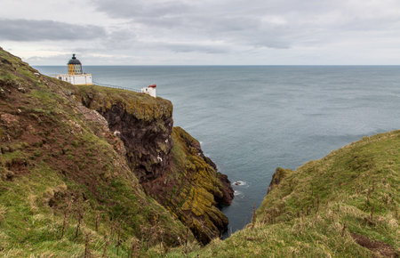 The Lighthouse and foghorn of St Abbs Head Lighthouse, perched on the cliff edge above the North Sea in Berwickshire, Scotlandの写真素材