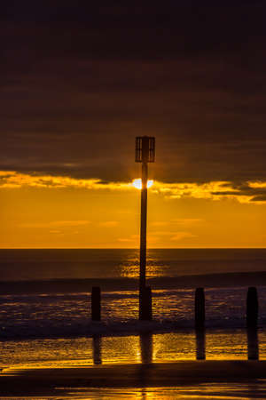 Sunrise to start the day at Blyth beach in Northumberland, with St Mary's Lighthouse in the distanceの写真素材