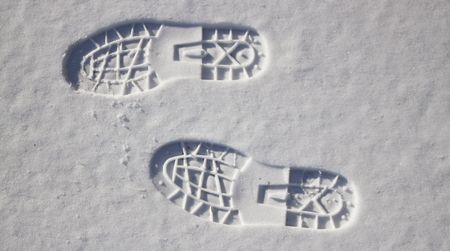a couple of deep footprints in the snowの写真素材